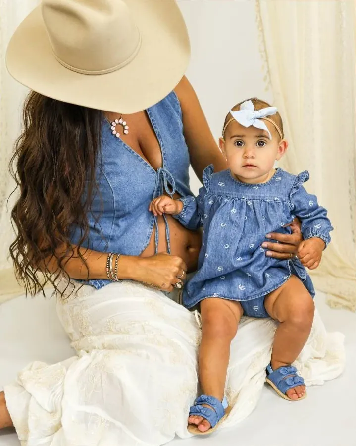 Mother and baby girl in matching denim at the studio